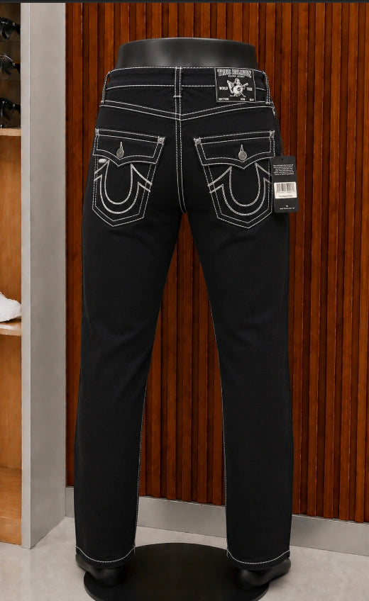 True Religion Ricky Straight Jeans featuring a monochromatic black wash with sharp contrast stitch detailing.
