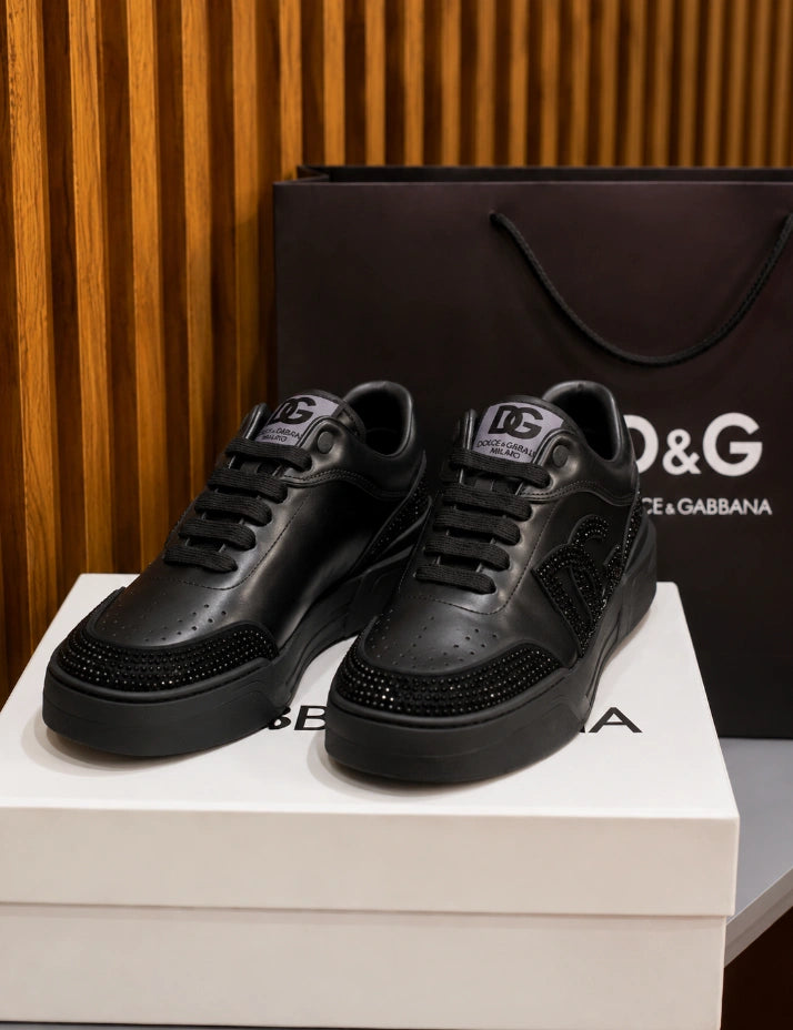 Dolce & Gabbana New Roma Rhinestone-Embellished Leather Sneakers in the Triple Black colorway.