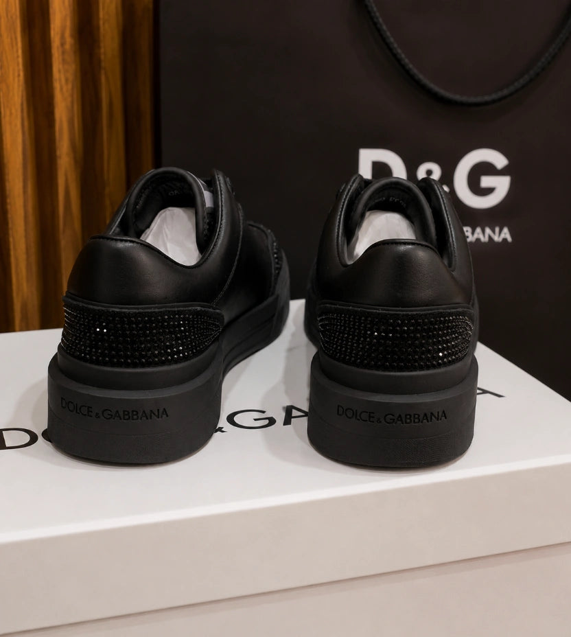 Dolce & Gabbana New Roma Rhinestone-Embellished Leather Sneakers in the Triple Black colorway.