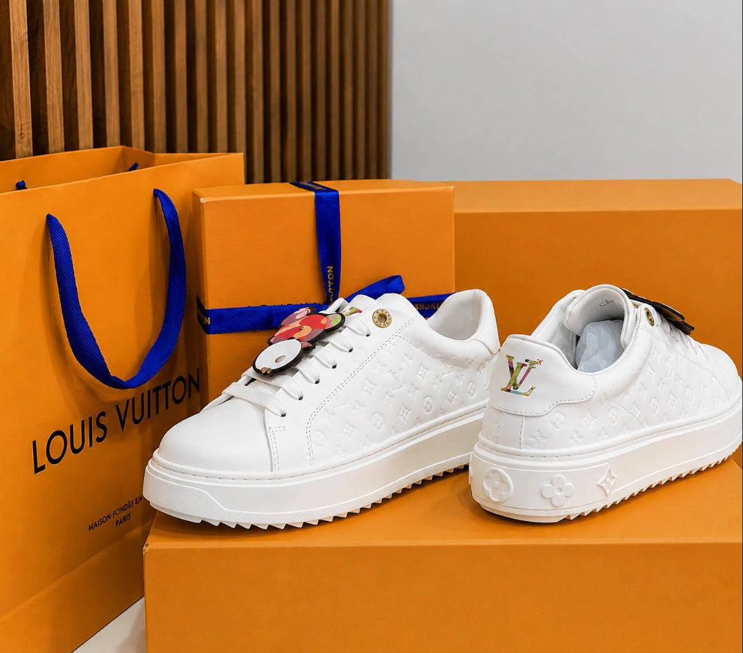 Louis Vuitton Time Out Sneakers in All-White Monogram Leather with Gold Accent.