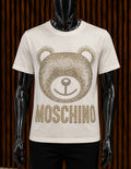 Moschino Studded Teddy Bear Cotton T-Shirt in an off-white/cream colorway.